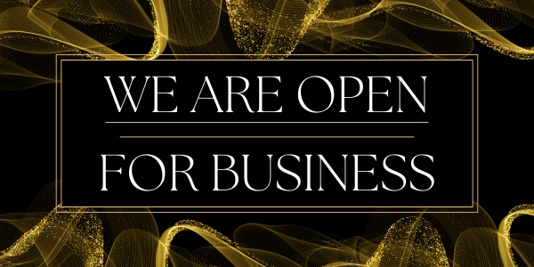 Text reading "We Are Open For Business" in elegant white font on a black background. Golden swirling patterns decorate the corners, adding a sophisticated touch that echoes the steps to success for our new business.