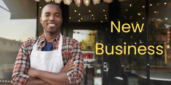 A smiling person in an apron stands before a store with glass doors, radiating the promise of thriving success. The words "New Business Venture" are proudly displayed, hinting at exciting prospects as we head toward 2025.