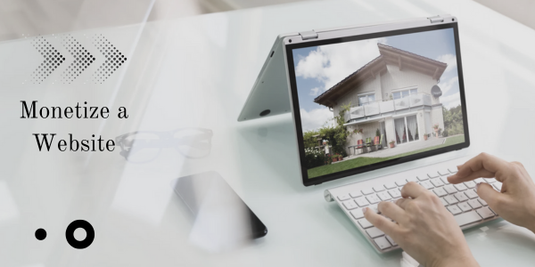 A person types on a keyboard connected to a tablet displaying a house photo. Text on the left reads "Monetize a Website" against a white background with abstract black geometric shapes, emphasizing the potential of leveraging SEO strategies to boost online revenue.